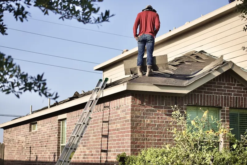 Professional roofer working on a residential roof in Ashton-Sandy Spring